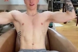 Tattooed English lad shows off his muscles on camera