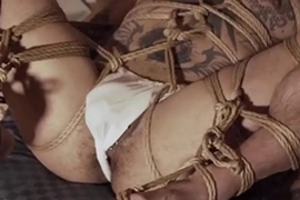 Yoshikawasaki, a hunky Asian jock, is bound and blindfolded, his piercings glistening under dim light. His body, adorned with intricate tattoos, writhes in anticipation of a hard spanking. This hardcore fetish video is a tantalizing display of Asian bondage.
