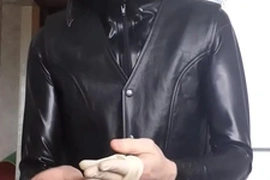 Guy in leather jacket putting gloves